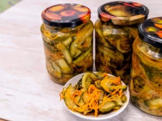 Agurksalat til vinteren med smør: opskrifter til syltning med hvidløg, med løg og tomater